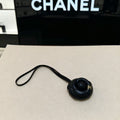 CHANEL CAMELLIA BAG CHARM IN BLACK LAMBSKIN