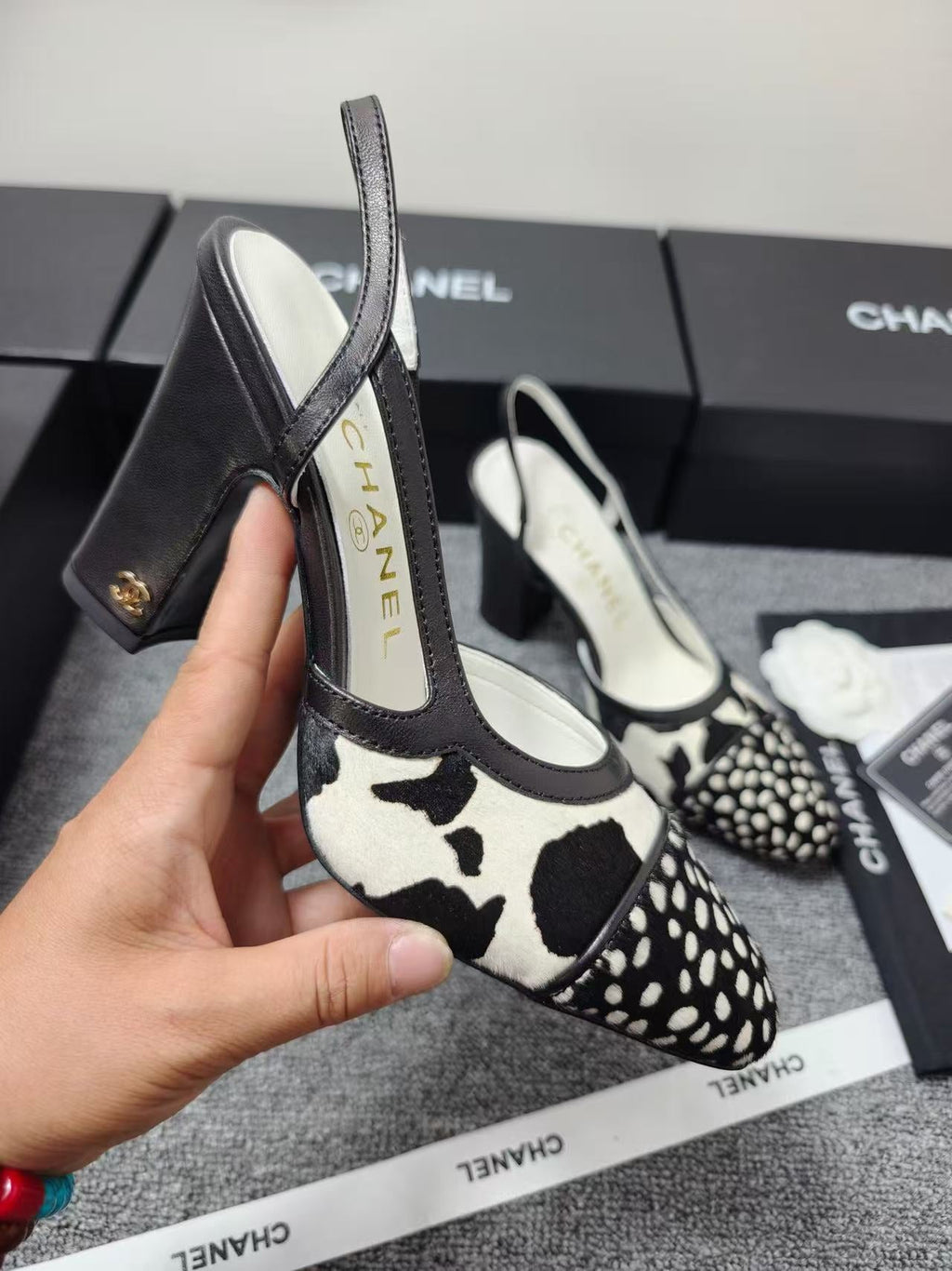CHANEL SLINGBACK HEELS IN BLACK AND WHITE COW PRINT
