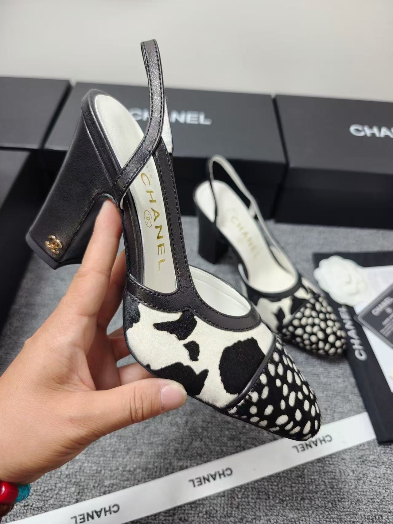 CHANEL SLINGBACK HEELS IN BLACK AND WHITE COW PRINT
