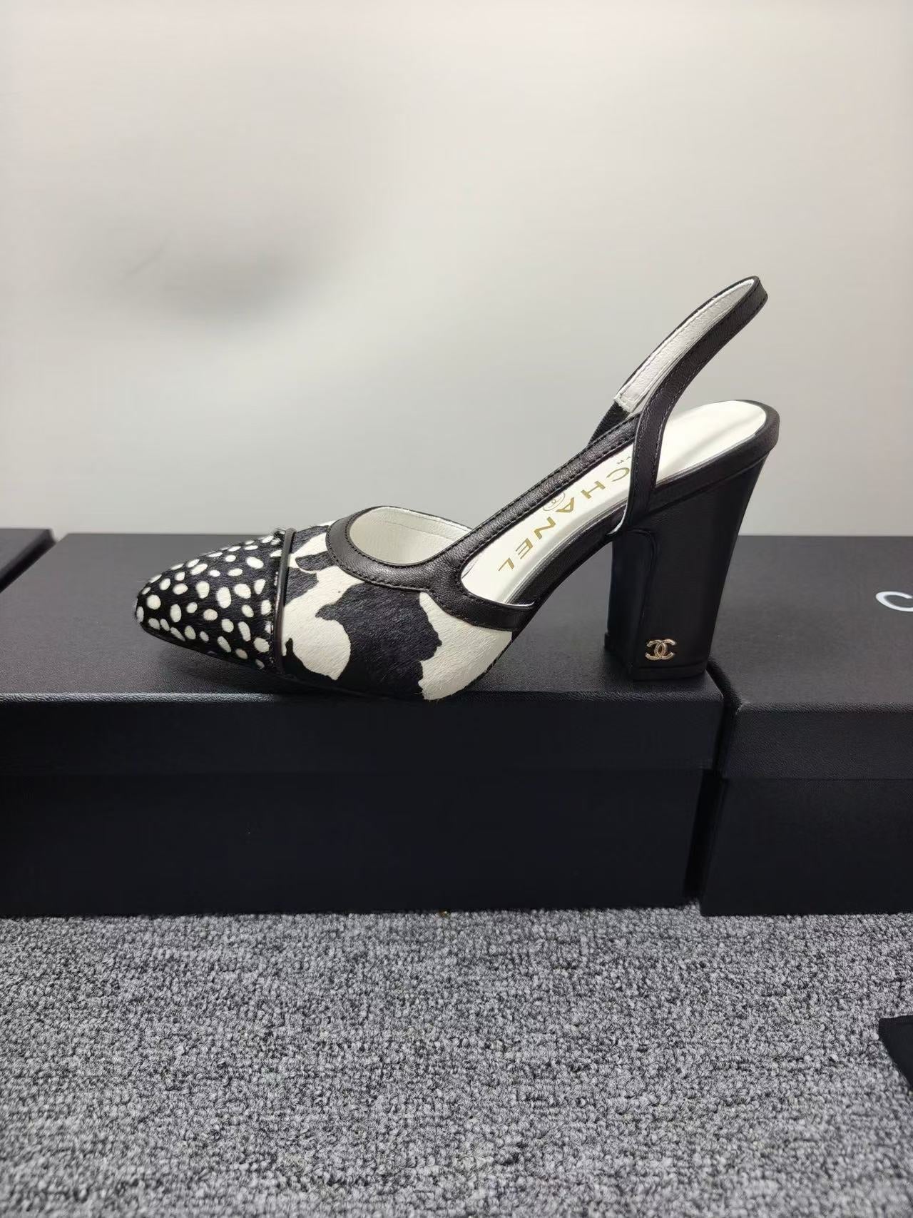 CHANEL SLINGBACK HEELS IN BLACK AND WHITE COW PRINT
