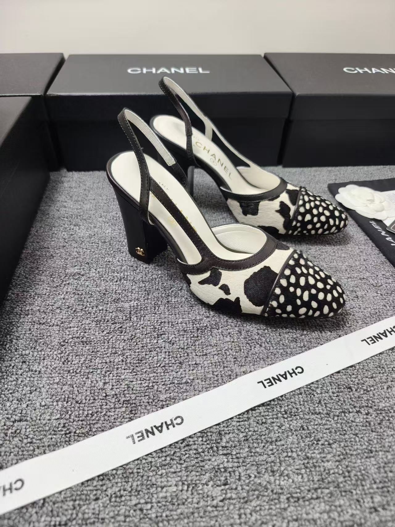 CHANEL SLINGBACK HEELS IN BLACK AND WHITE COW PRINT
