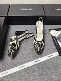 CHANEL SLINGBACK HEELS IN BLACK AND WHITE COW PRINT