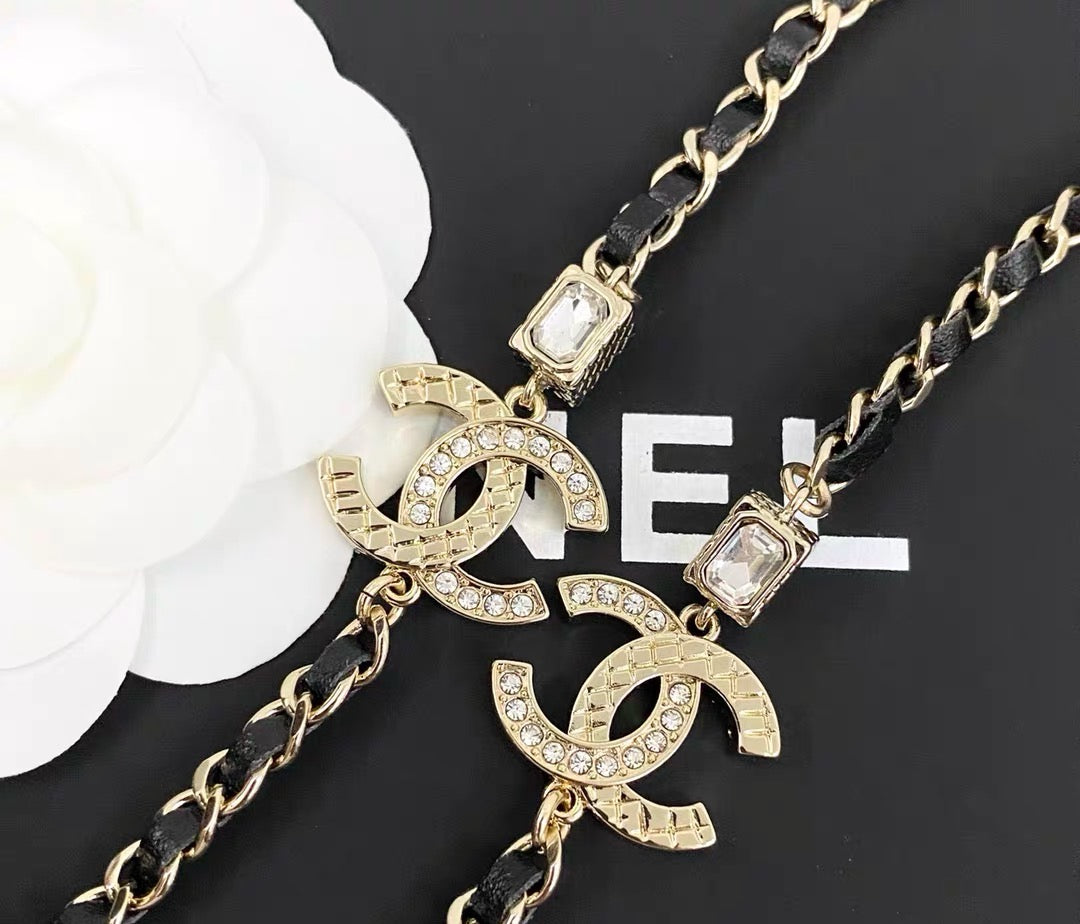 GOLD-TONE CHANEL CHAIN BELT WITH BLACK ENAMEL AND CRYSTAL-ENCRUSTED INTERLOCKING CC CHARMS