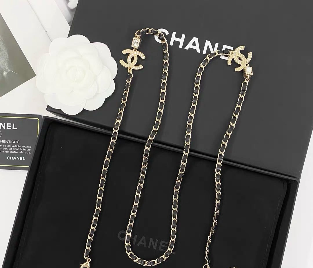 GOLD-TONE CHANEL CHAIN BELT WITH BLACK ENAMEL AND CRYSTAL-ENCRUSTED INTERLOCKING CC CHARMS