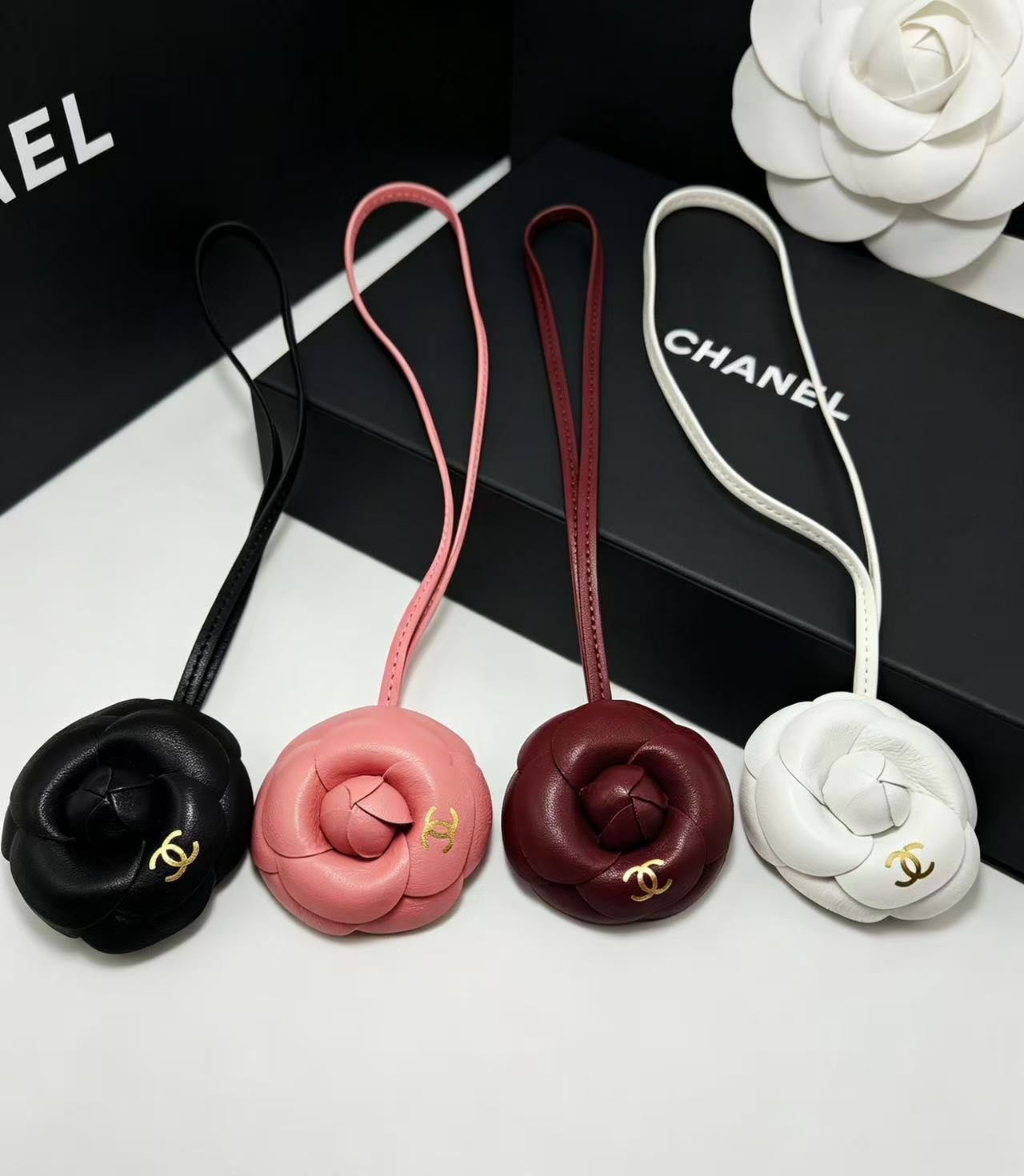 CHANEL CAMELLIA BAG CHARM IN BLACK LAMBSKIN