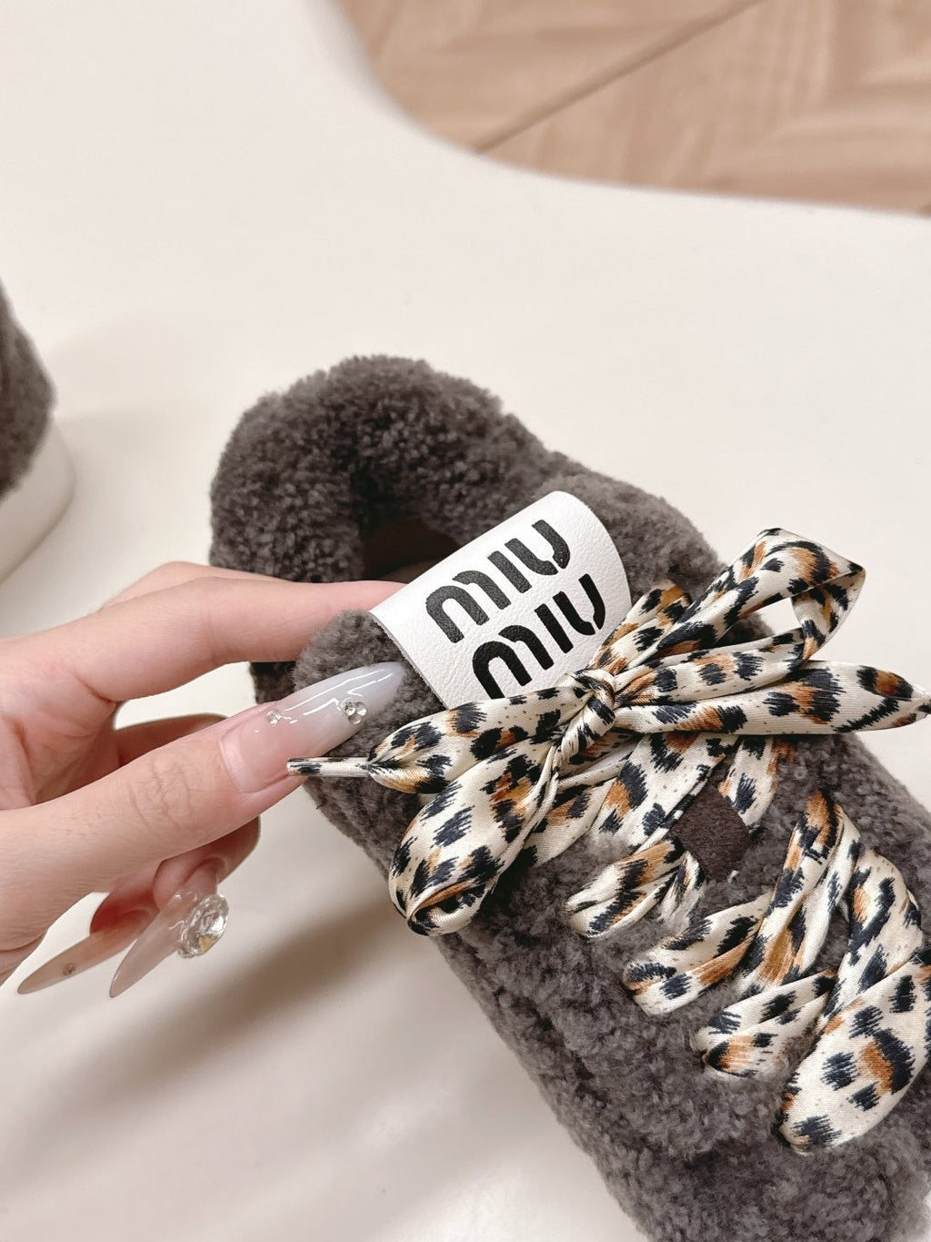 MIUMIU 25S SNEAKERS IN DARK BROWN SHEARLING WITH LEOPARD-PRINT LACES