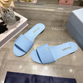 PRADA 26S LOGO EMBOSSED SLIDE SANDALS IN SKY BLUE PATENT CALFSKIN