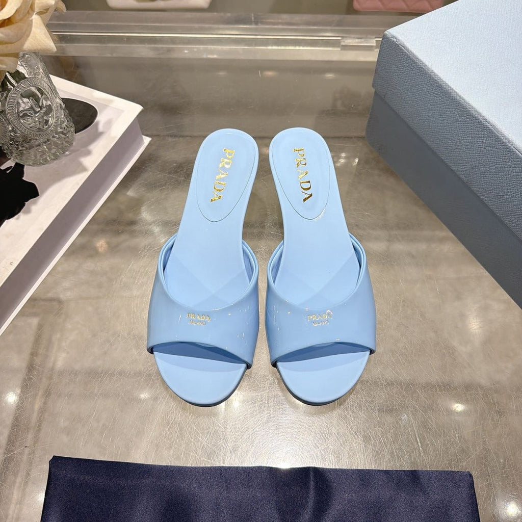 PRADA 26S LOGO EMBOSSED KITTEN HEEL MULES IN SKY BLUE PATENT CALFSKIN