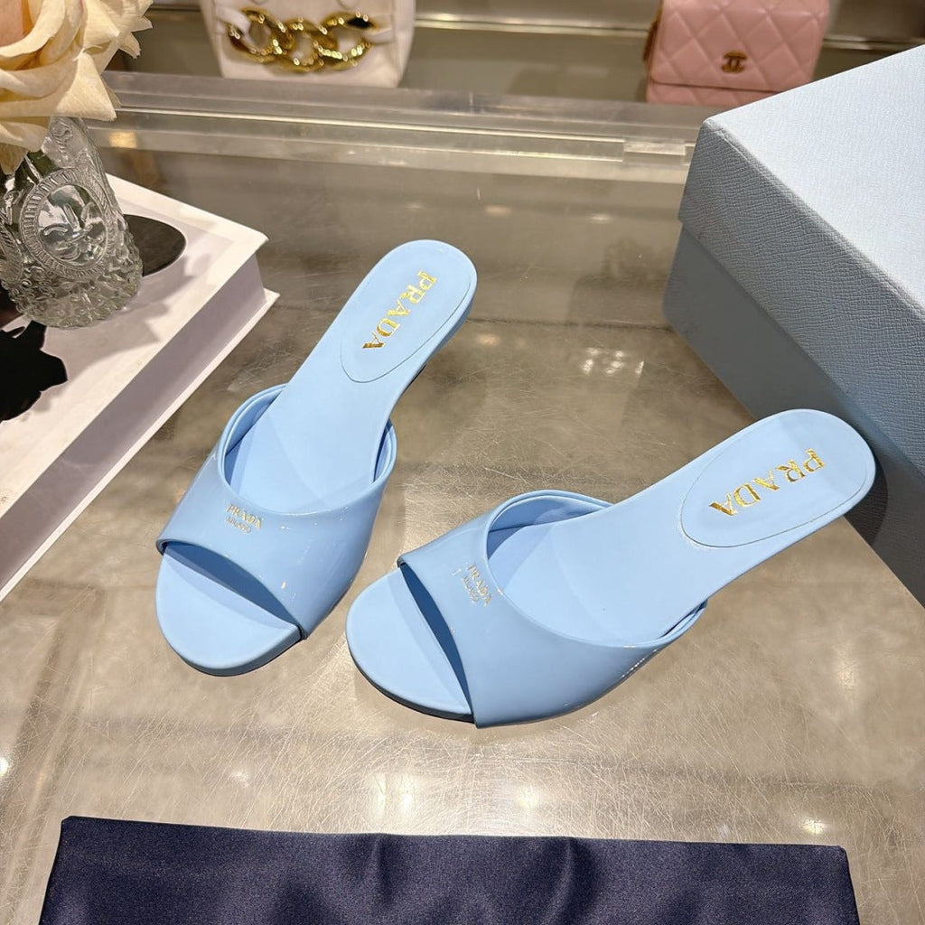 PRADA 26S LOGO EMBOSSED KITTEN HEEL MULES IN SKY BLUE PATENT CALFSKIN