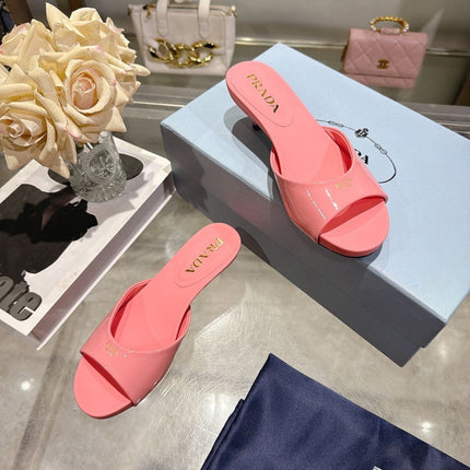 PRADA 26S LOGO EMBOSSED KITTEN HEEL MULES IN PINK PATENT CALFSKIN