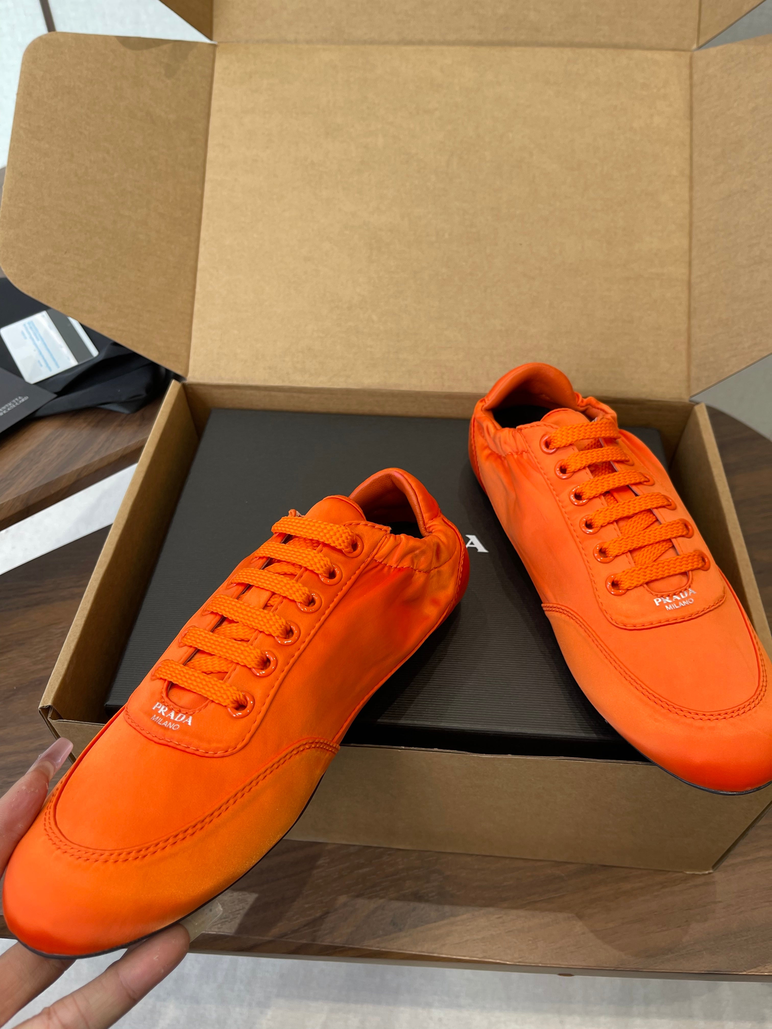PRADA 25S SNEAKER IN ORANGE SILK