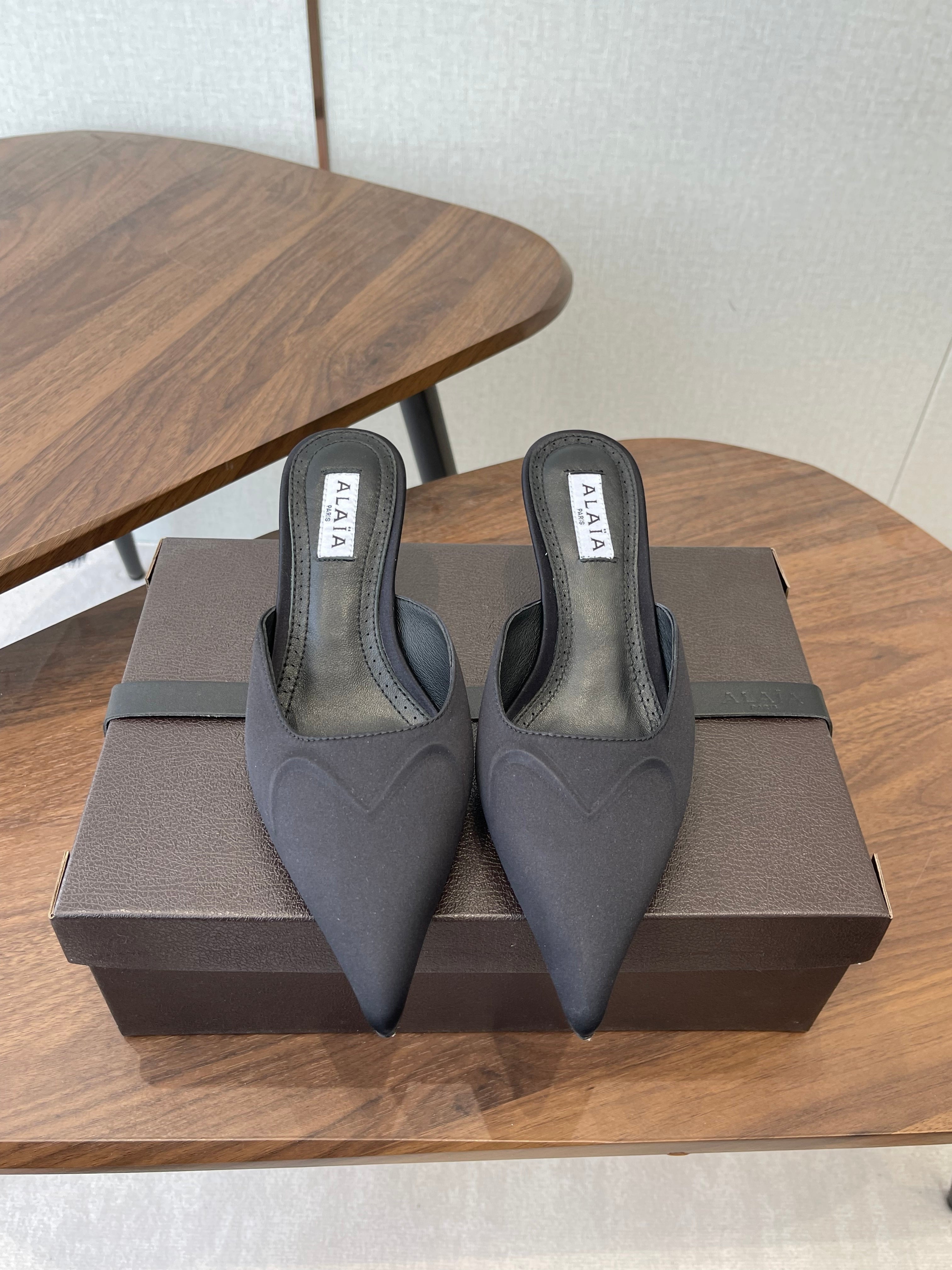 ALAIA 26S HEELED MULES 50 MM IN BLACK FABRIC