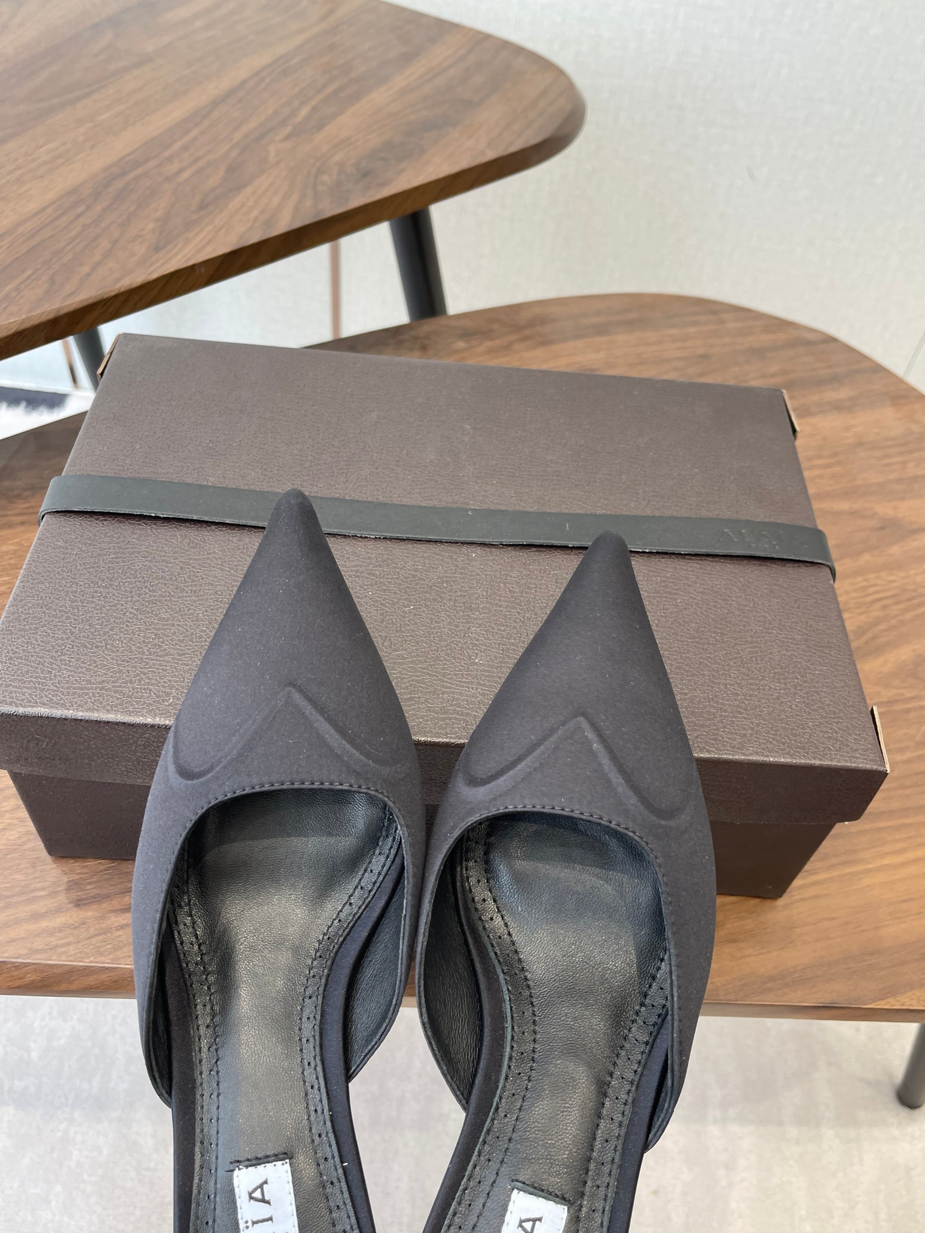 ALAIA 26S HEELED MULES 50 MM IN BLACK FABRIC
