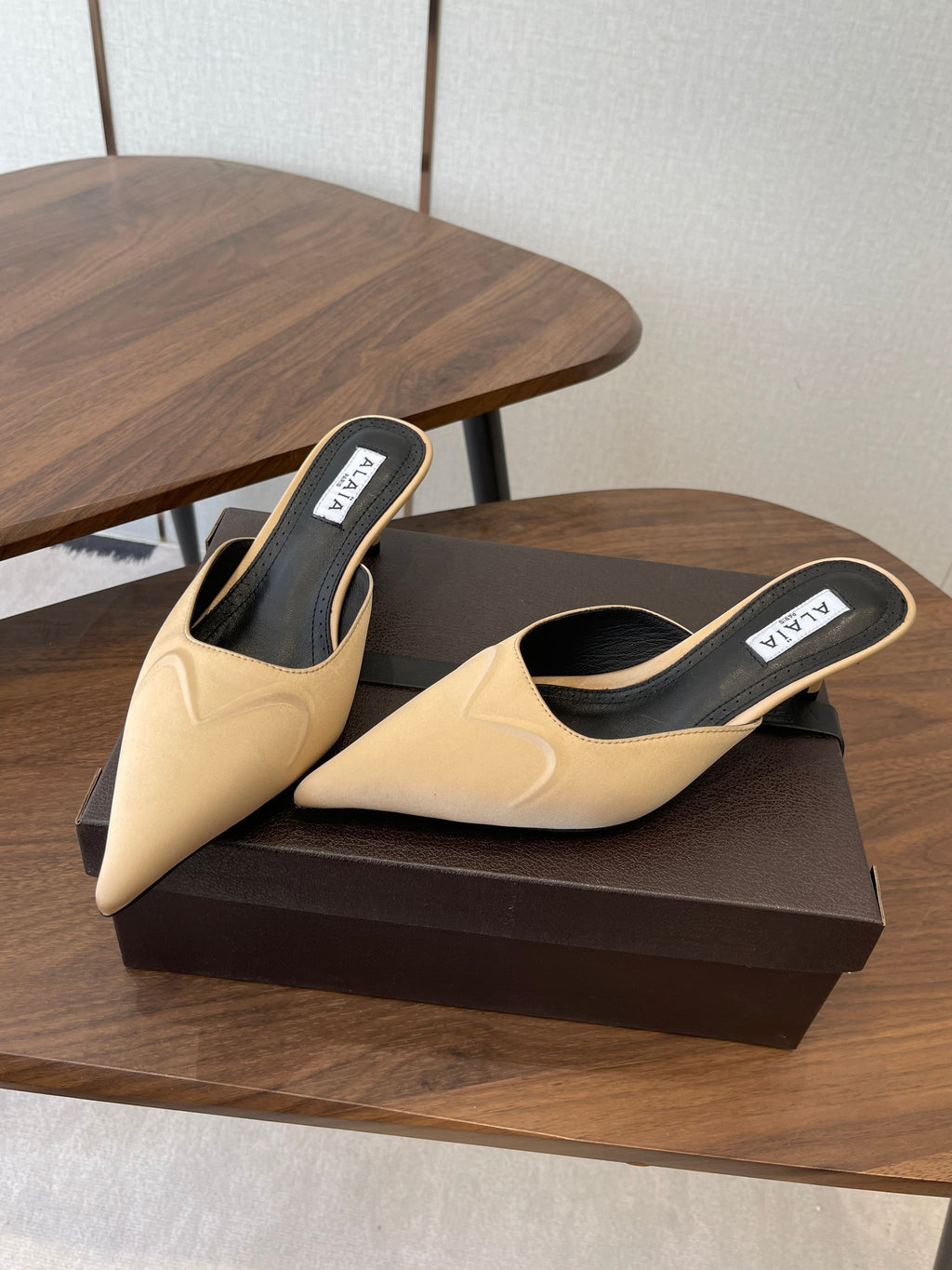 ALAIA 26S HEELED MULES 50 MM IN WARM BEIGE FABRIC