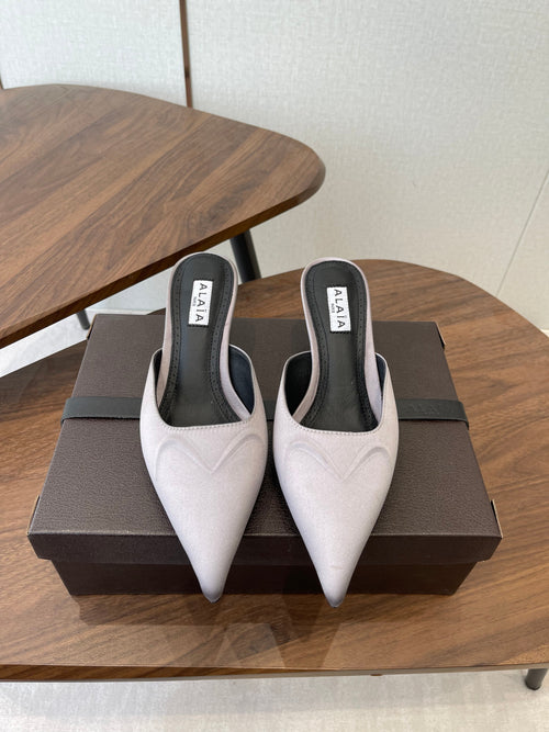 ALAIA 26S HEELED MULES 50 MM IN LAVENDER GREY FABRIC