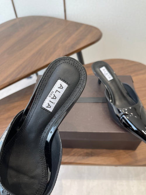 ALAIA 26S HEELED MULES 50 MM IN BLACK GLOSSY CALFSKIN