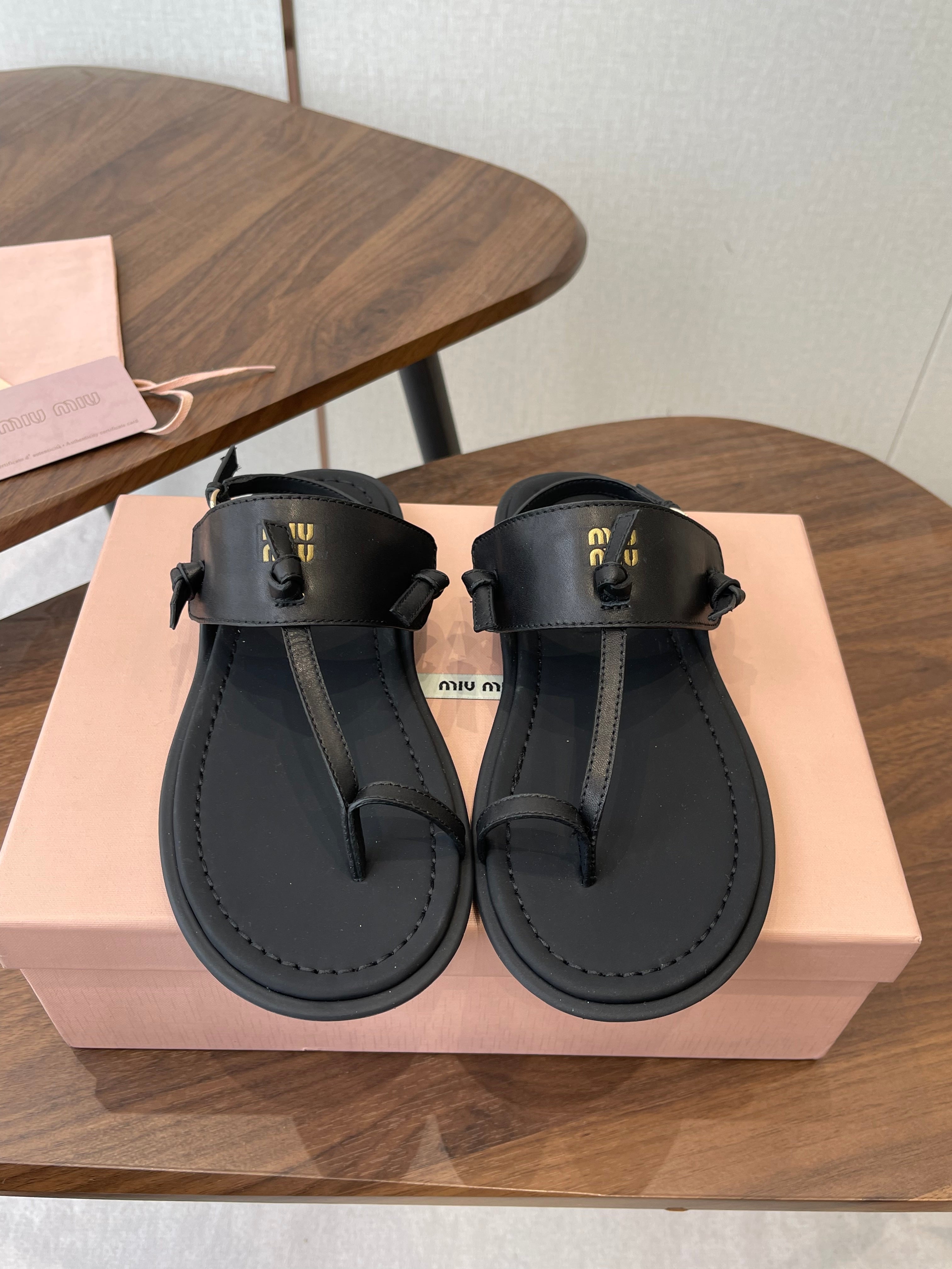 MIUMIU 26S FLIP FLOPS IN BLACK CALFSKIN