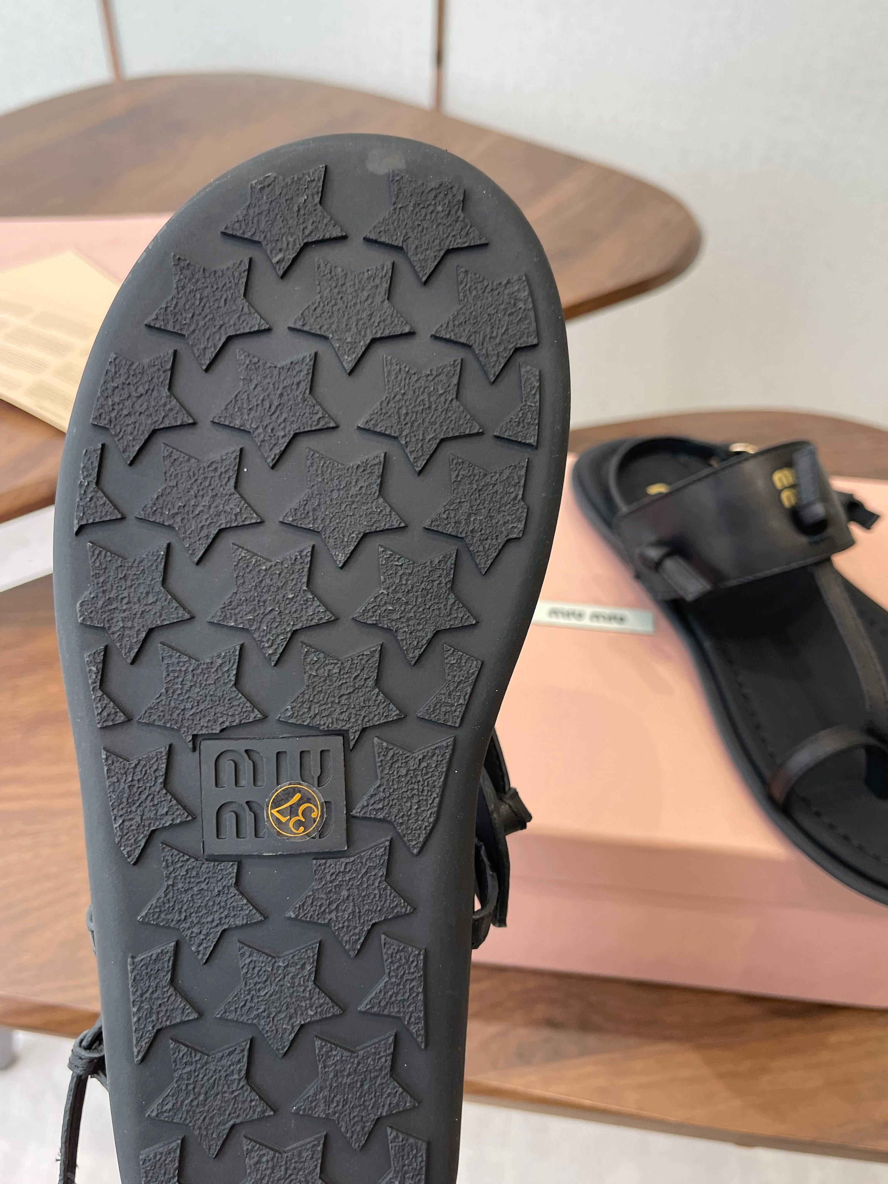 MIUMIU 26S FLIP FLOPS IN BLACK CALFSKIN