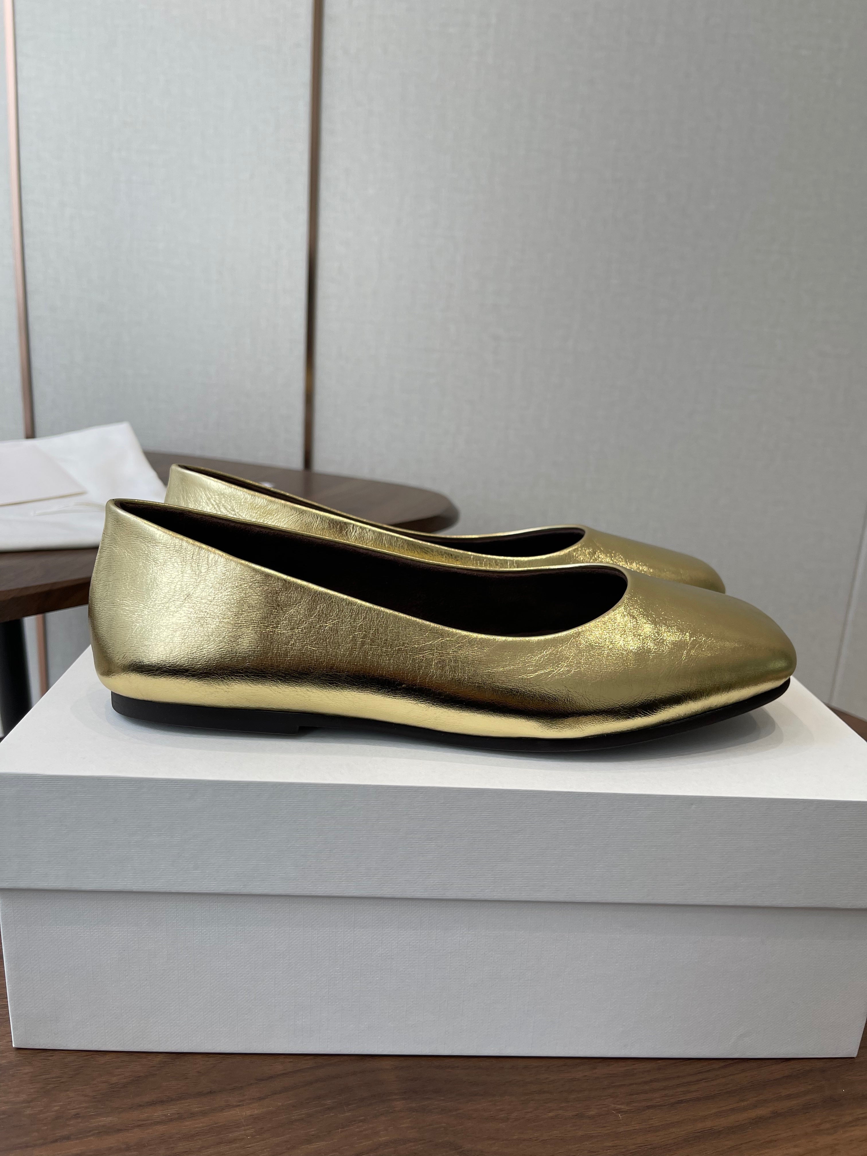 THE ROW 26S FLATS IN GOLD CALFSKIN
