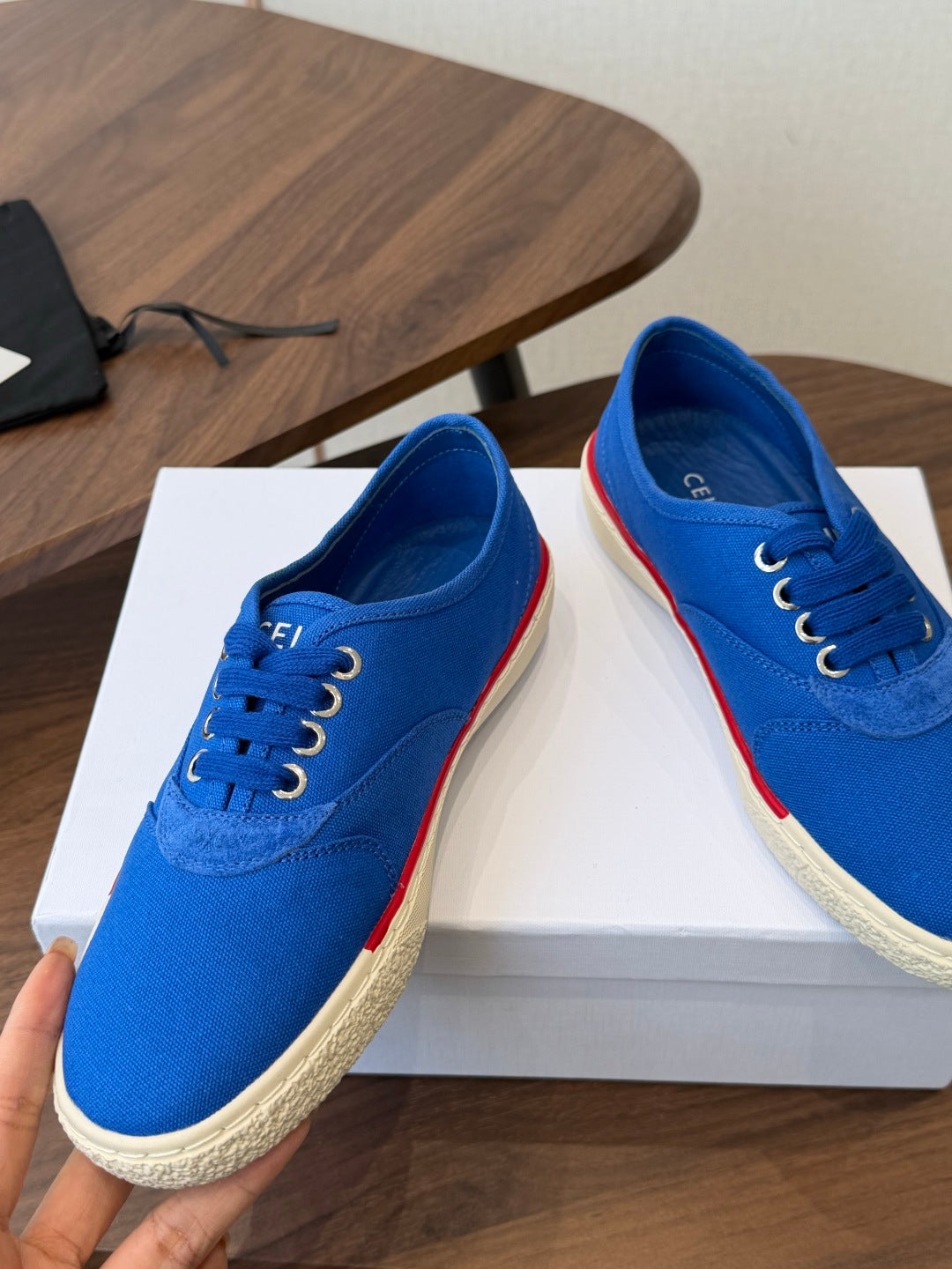 CELINE 26S TRIOMPHE LOW TOP SNEAKERS IN BLUE CANVAS RED TRIM