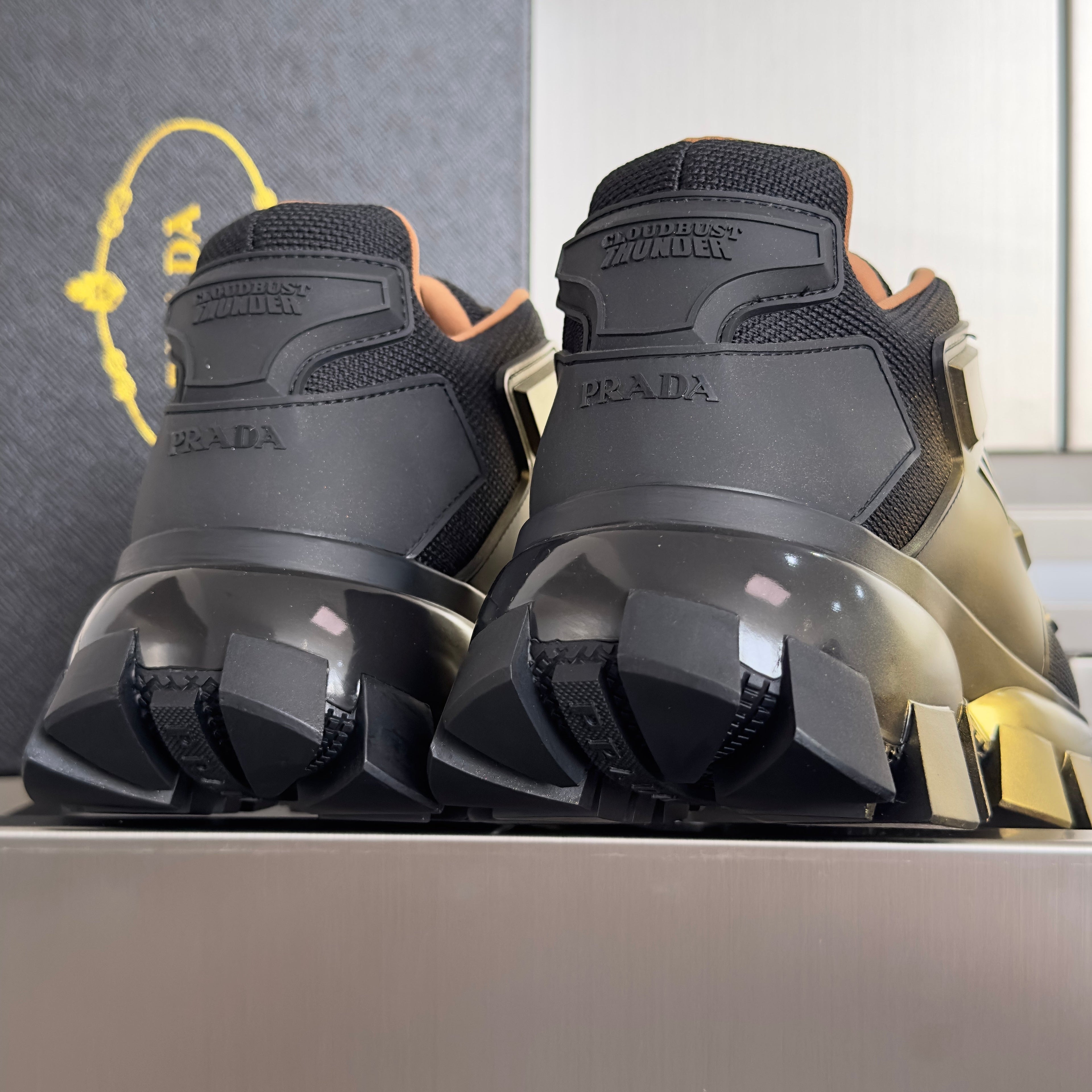 PRADA 26S CLOUDBUST THUNDER SNEAKERS 60MM IN BLACK AND GOLD MESH FABRIC AND TPU