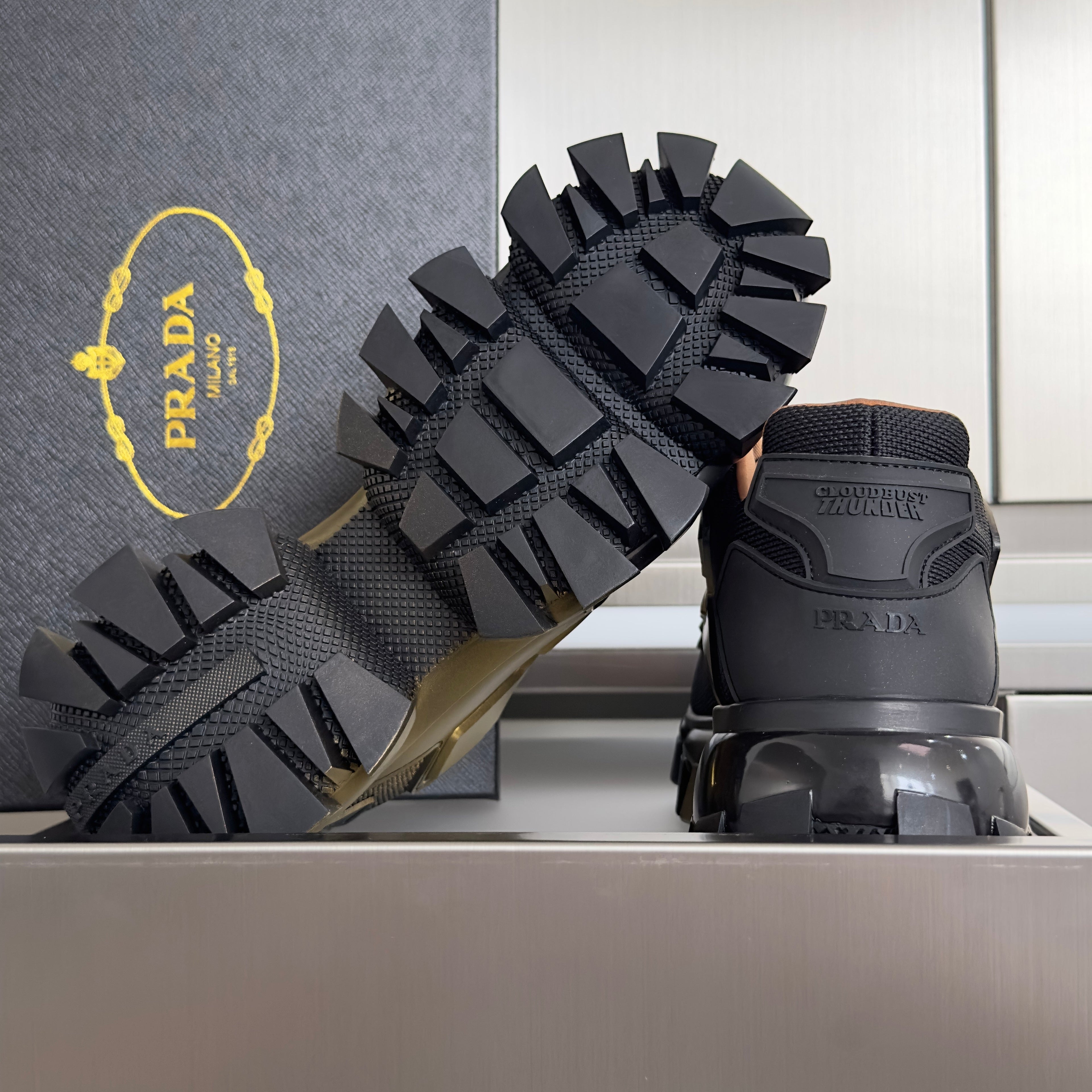 PRADA 26S CLOUDBUST THUNDER SNEAKERS 60MM IN BLACK AND GOLD MESH FABRIC AND TPU