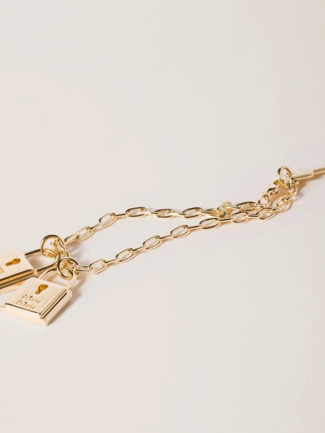 MIUMIU 26S DOUBLE PADLOCK CHARM CHAIN BRACELET IN GOLD TONE METAL 619260