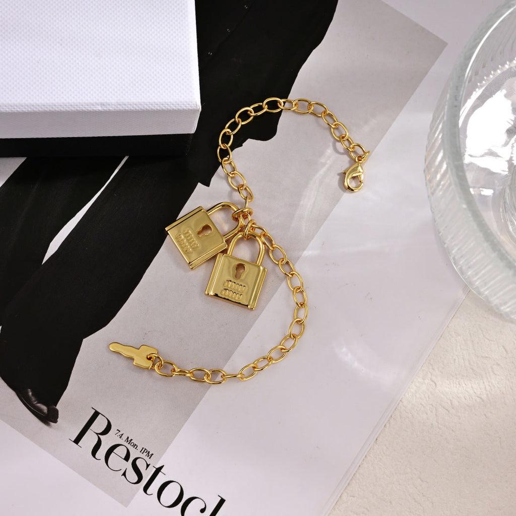 MIUMIU 26S DOUBLE PADLOCK CHARM CHAIN BRACELET IN GOLD TONE METAL 619260