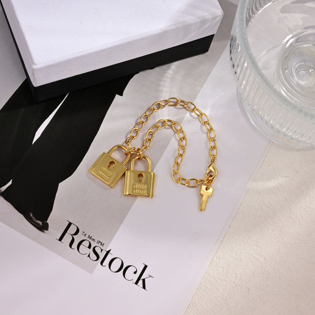 MIUMIU 26S DOUBLE PADLOCK CHARM CHAIN BRACELET IN GOLD TONE METAL 619260
