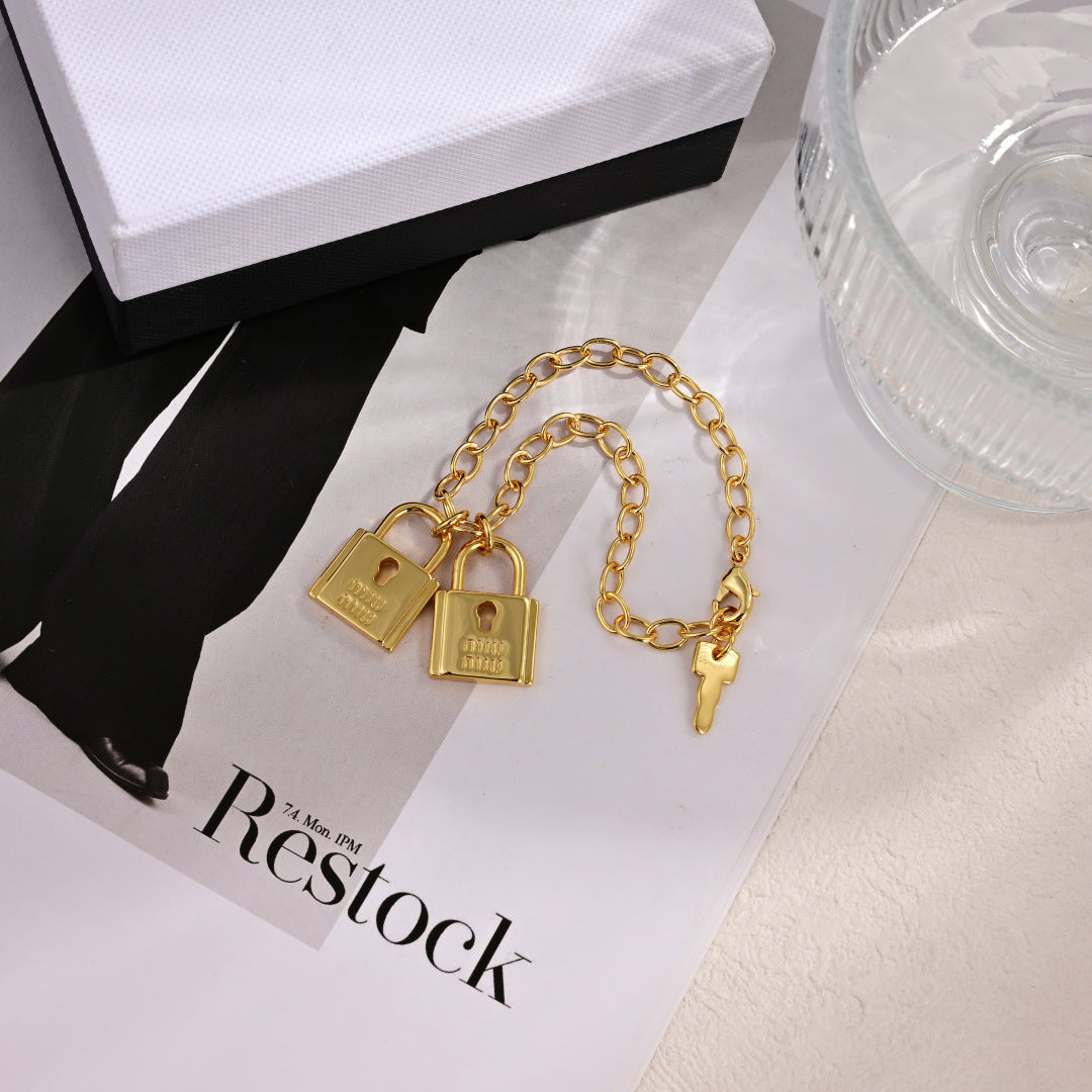 MIUMIU 26S DOUBLE PADLOCK CHARM CHAIN BRACELET IN GOLD TONE METAL 619260