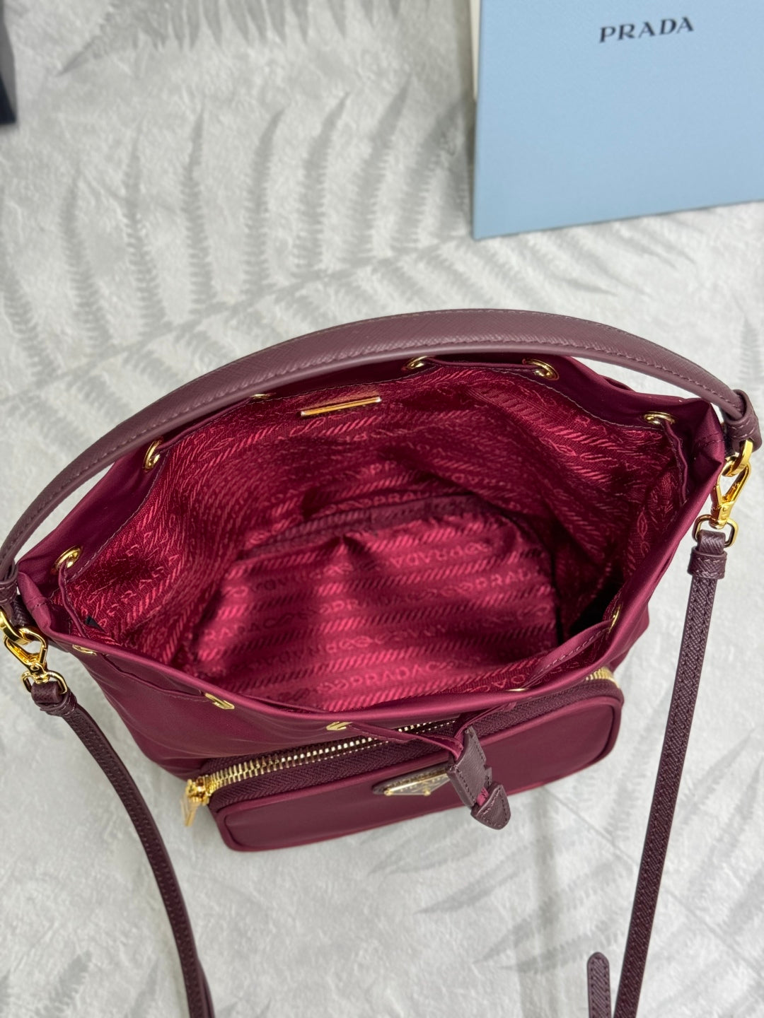 PRADA 25S DUET BUCKET BAG 23 IN BURGUNDY RE-NYLON GOLD HARDWARE