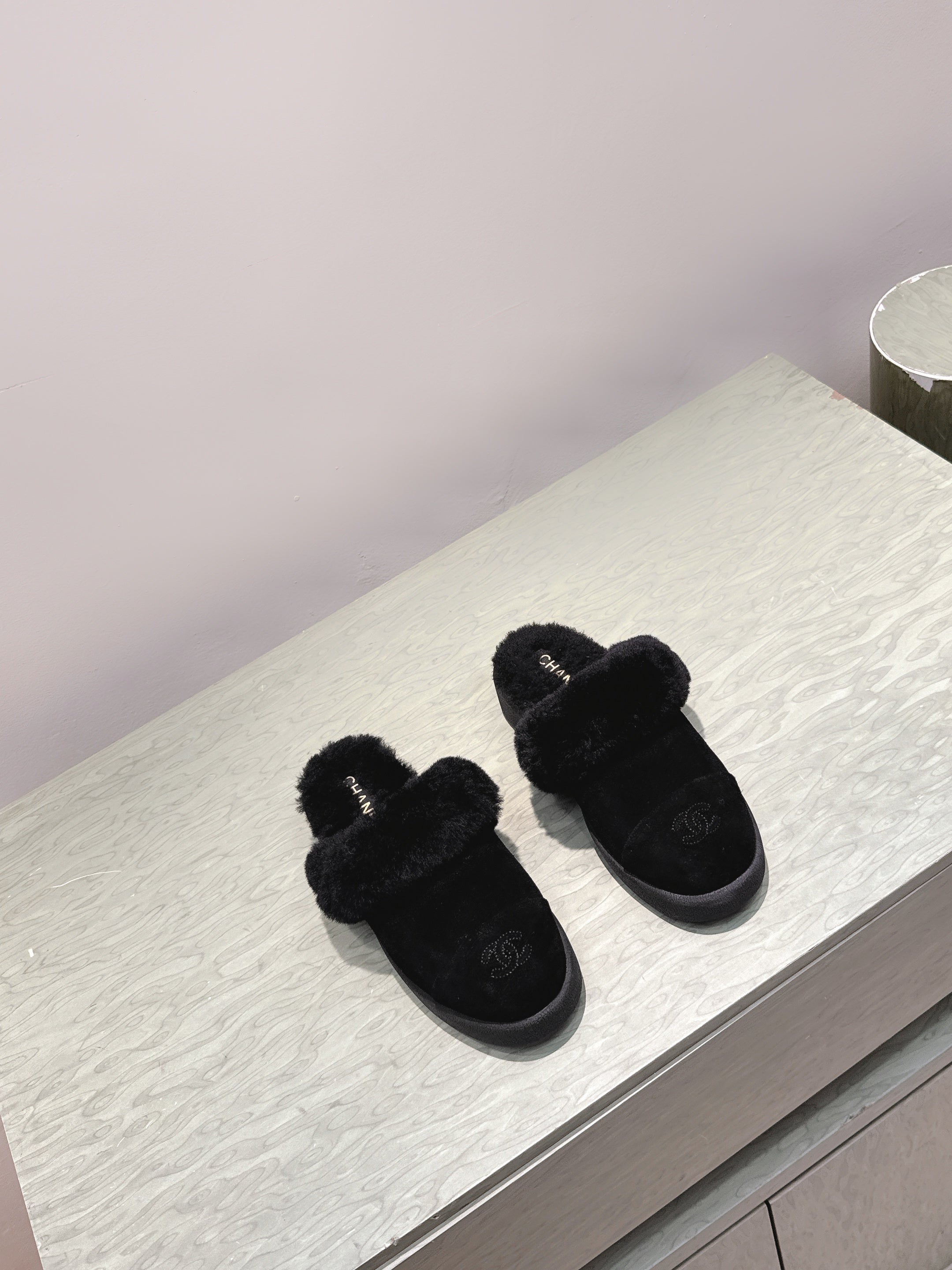 CHANEL 25S FUR-LINED MULES IN BLACK SUEDE
