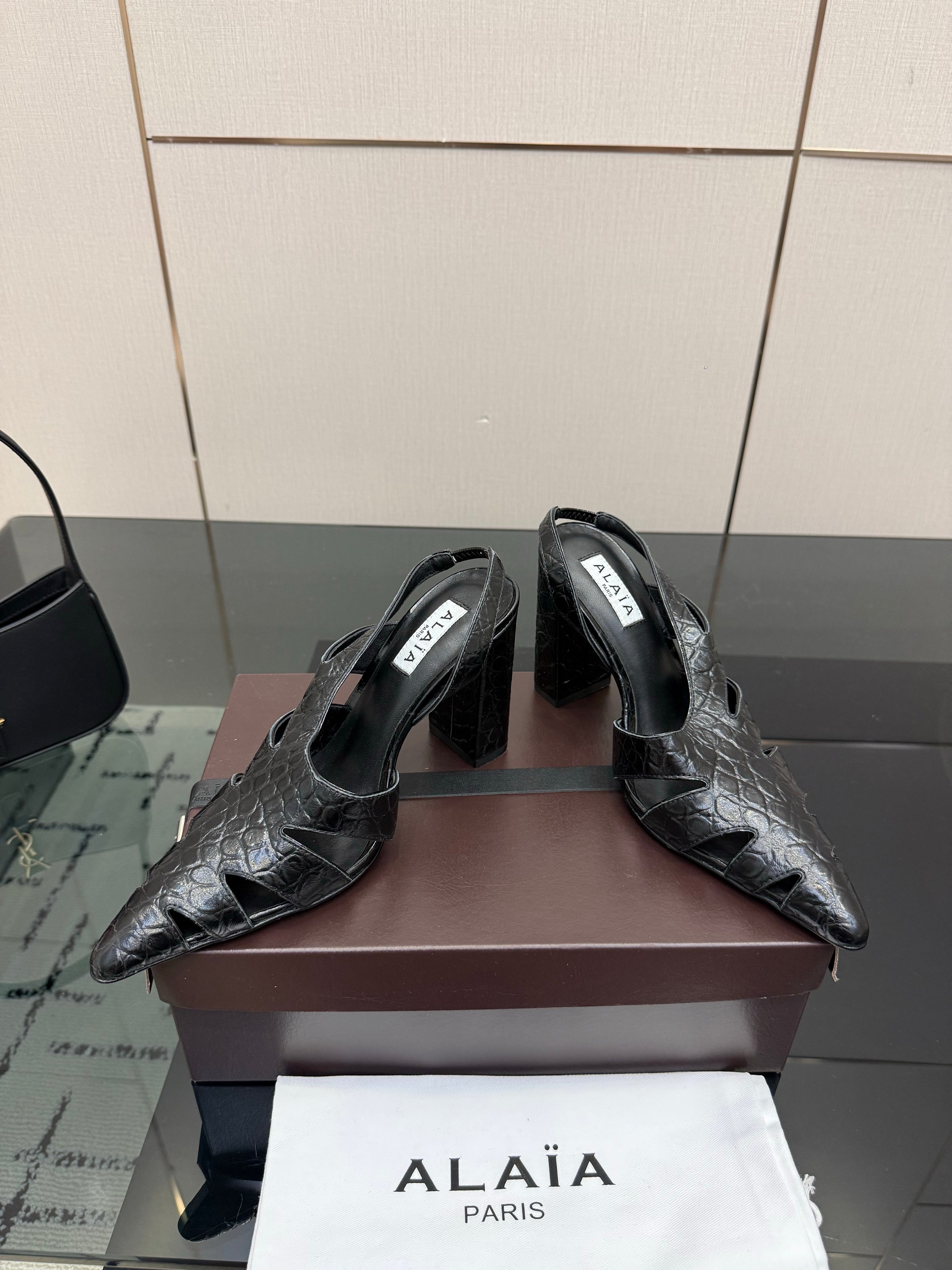 ALAIA 26S HEELED SLINGBACKS IN BLACK CROC-EMBOSSED LEATHER
