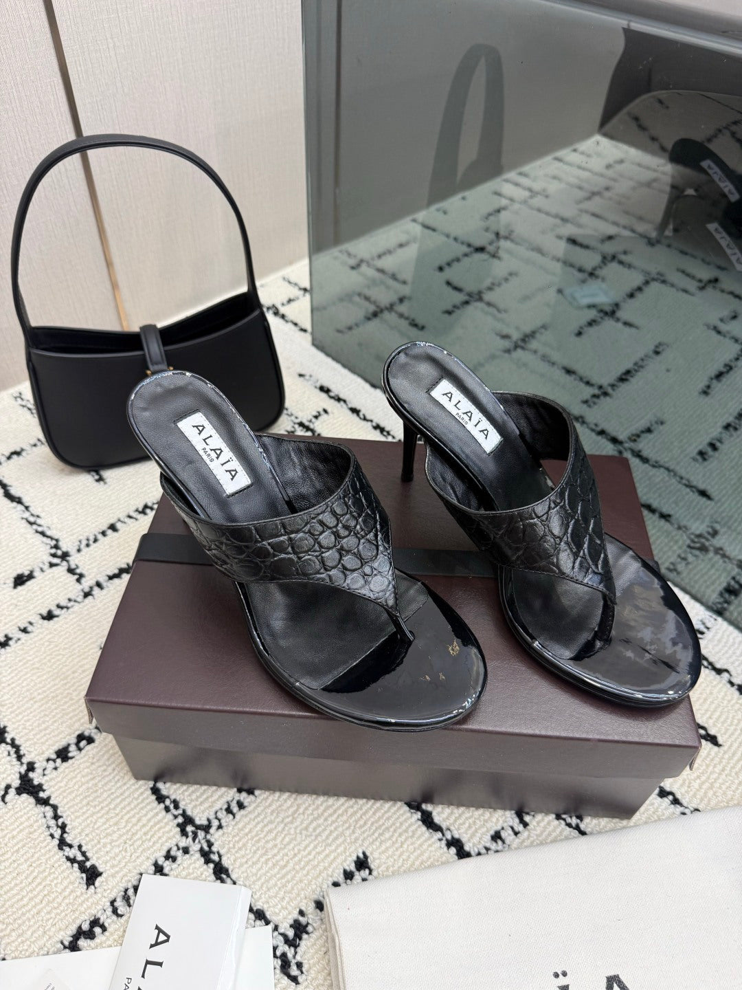 ALAIA 26S HEELED THONG MULE SANDALS IN BLACK CALFSKIN