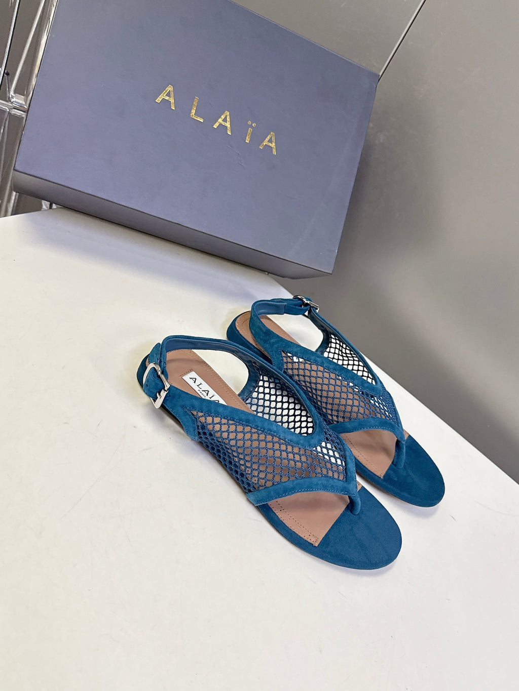 ALAIA 26S FLAT MESH THONG SANDALS IN PETROL BLUE SUEDE