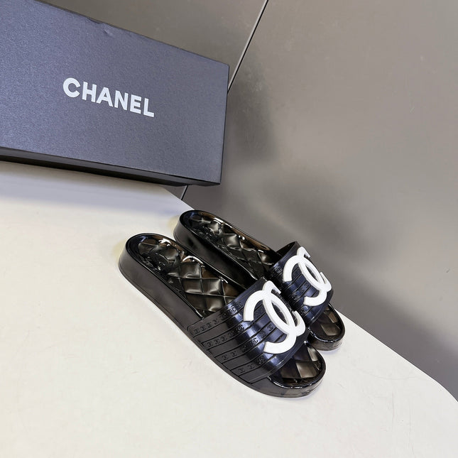 CHANEL 26S SLIDES IN BLACK PVC WITH WHITE LOGO