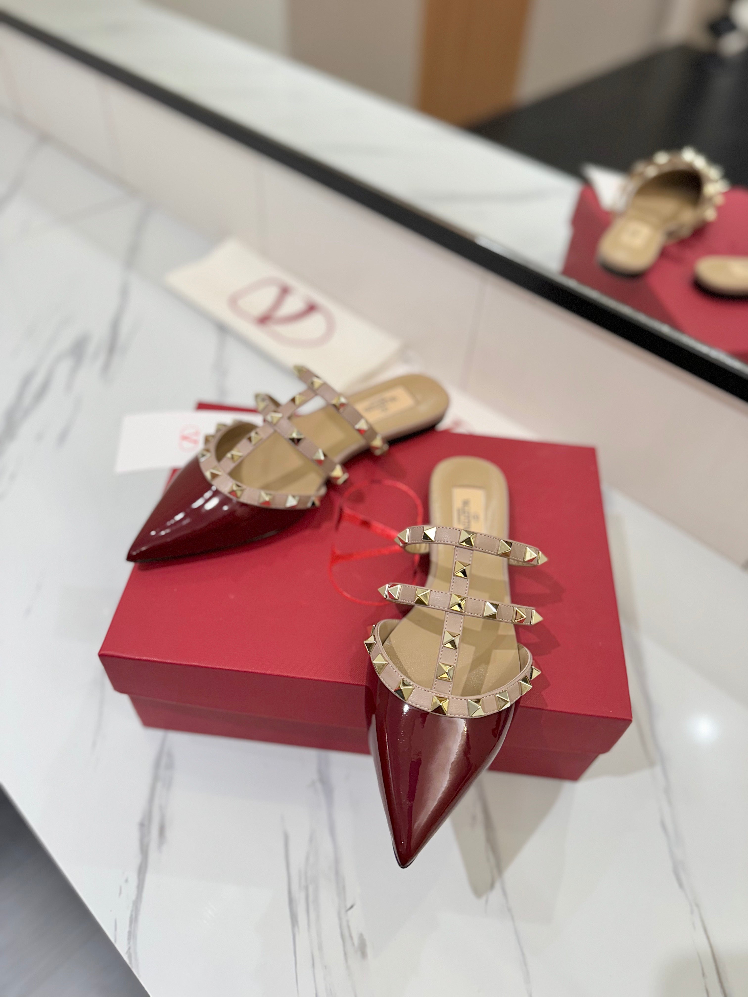 VALENTINO 26S STUDDED FLAT MULES IN DARK RED PATENT CALFSKIN
