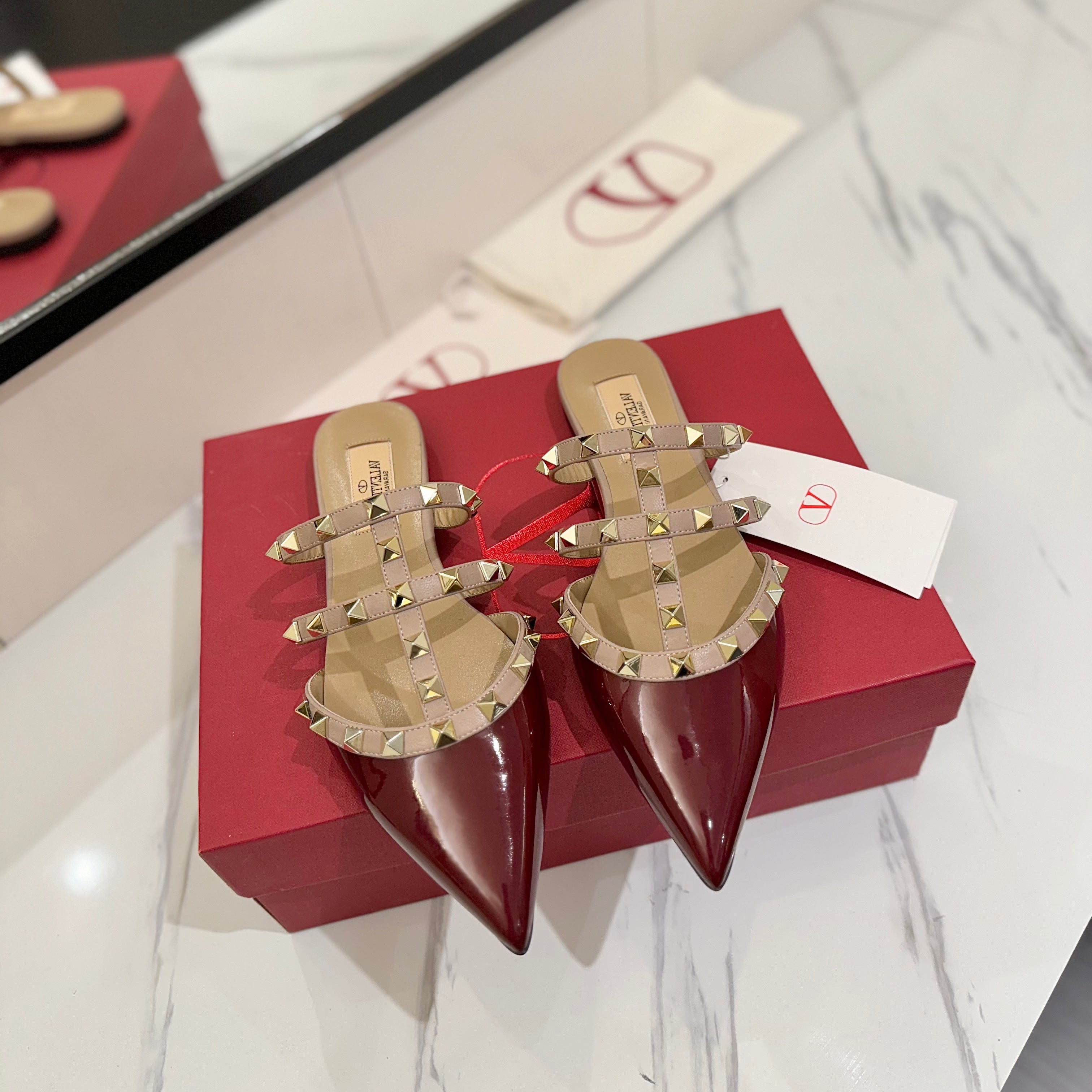 VALENTINO 26S STUDDED FLAT MULES IN DARK RED PATENT CALFSKIN