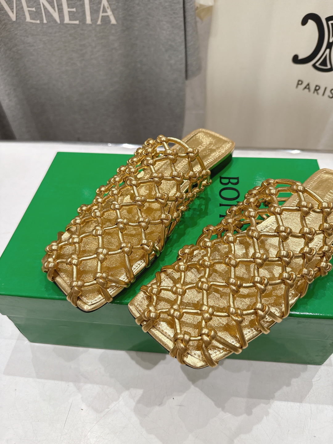 BOTTEGA VENETA 26S WOVEN MULES IN GOLD LAMBSKIN
