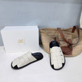 THE ROW 26S CAGE SLIDES IN IVORY WHITE SMOOTH CALFSKIN WITH BLACK FOOTBED