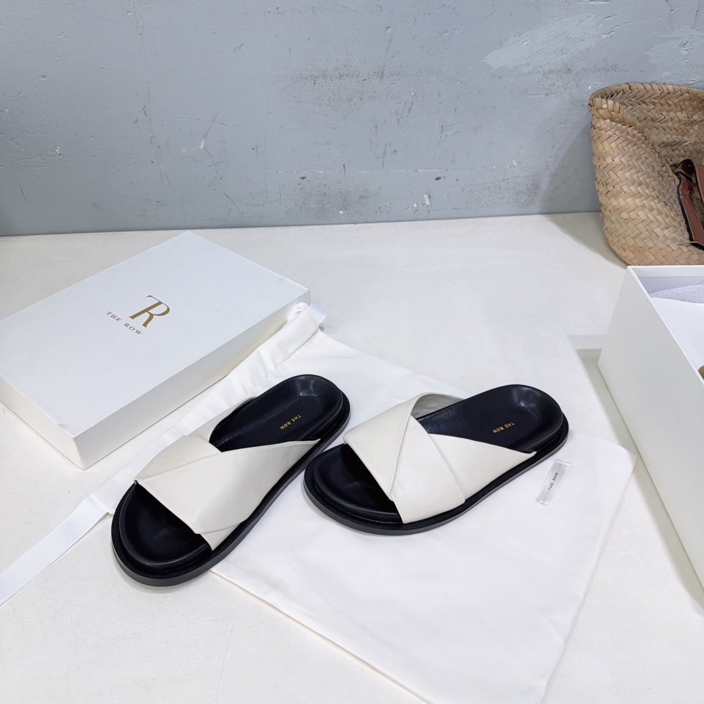THE ROW 26S CROSS STRAP SLIDES IN IVORY WHITE CALFSKIN WITH BLACK FOOTBED