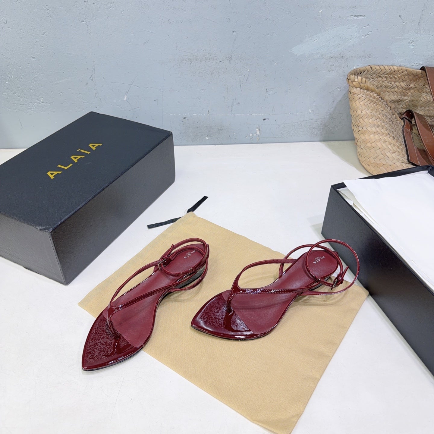 ALAIA 26S THONG SANDALS IN DARK RED CALFSKIN
