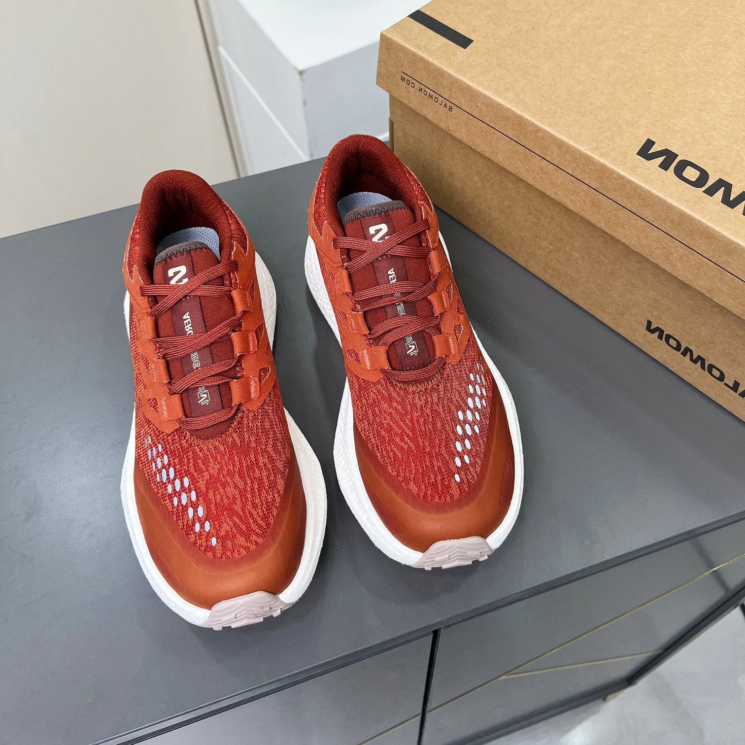 ALO 25S SALOMON ODYSSEY ELMT SNEAKER 45 MM IN DARK ORANGE FABRIC