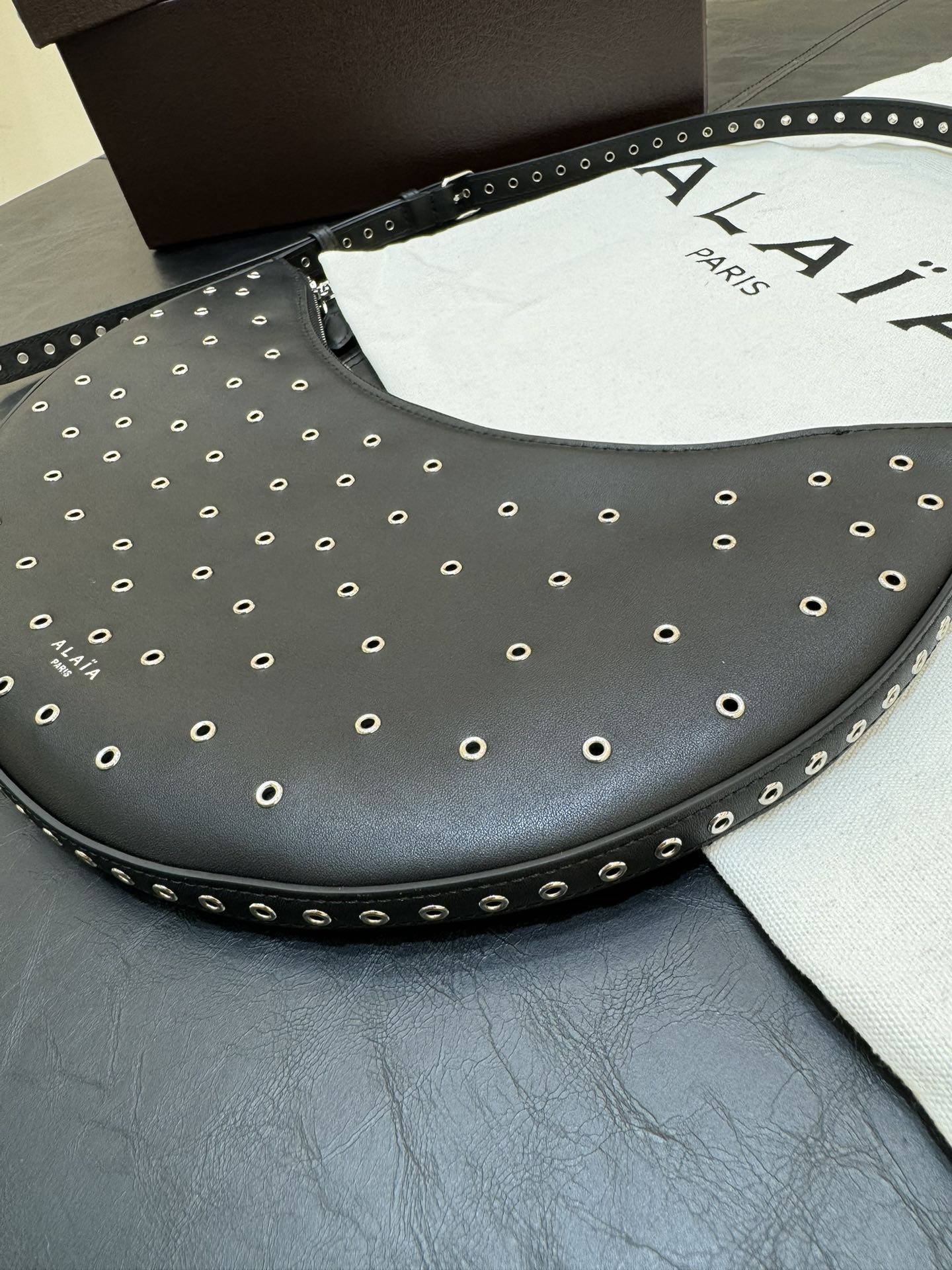 ONE PIECE DEMI LUNE BAG 31 IN BLACK SHEEPSKIN EYELET DETAILING