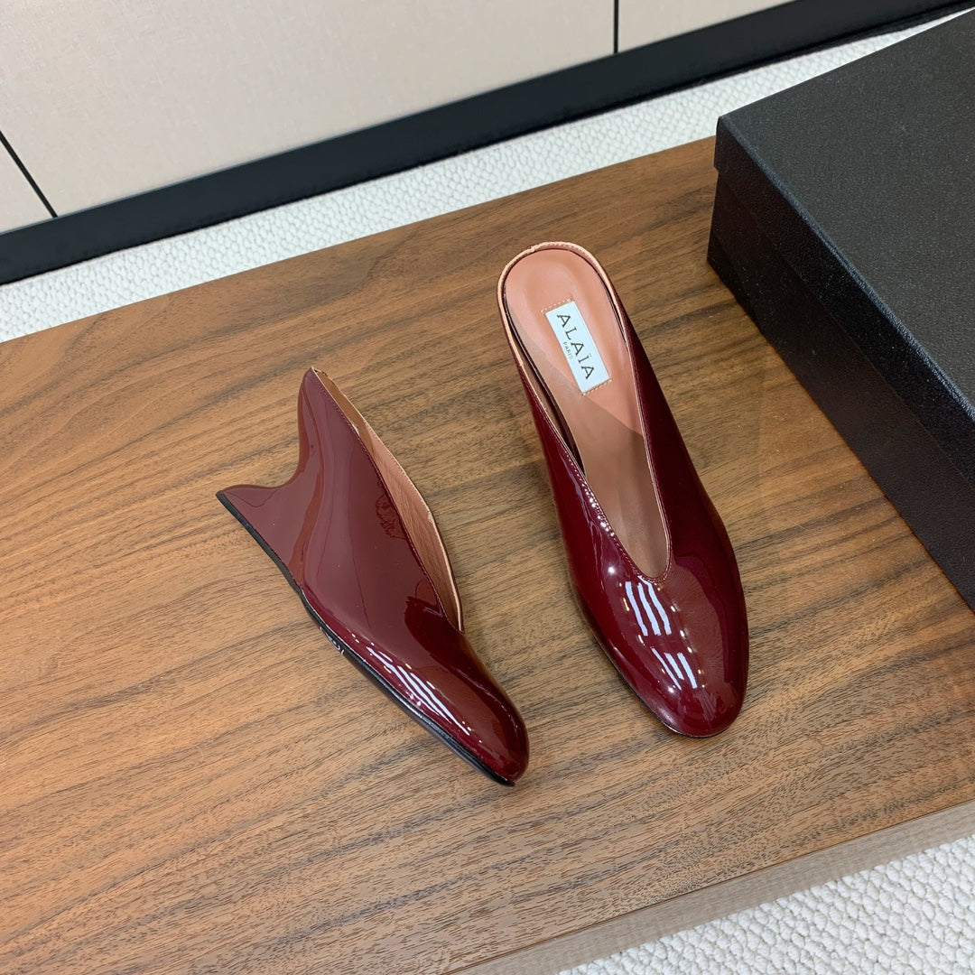 ALAIA 26S WEDGE MULES 70 MM IN DARK RED GLOSSY CALFSKIN
