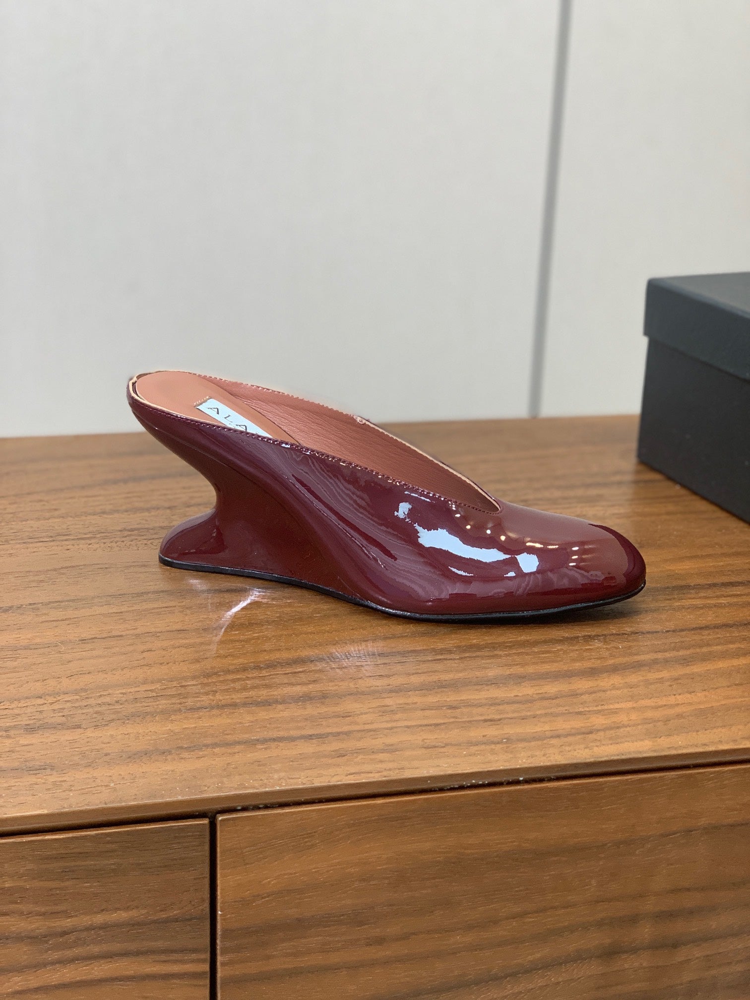 ALAIA 26S WEDGE MULES 70 MM IN DARK RED GLOSSY CALFSKIN