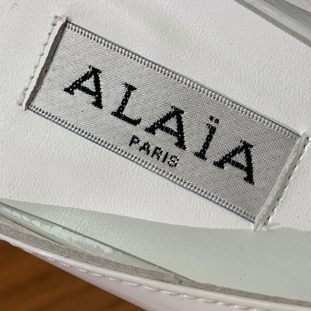 ALAIA 26S WEDGE MULES 70 MM IN WHITE GLOSSY CALFSKIN