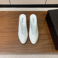 ALAIA 26S WEDGE MULES 70 MM IN WHITE GLOSSY CALFSKIN