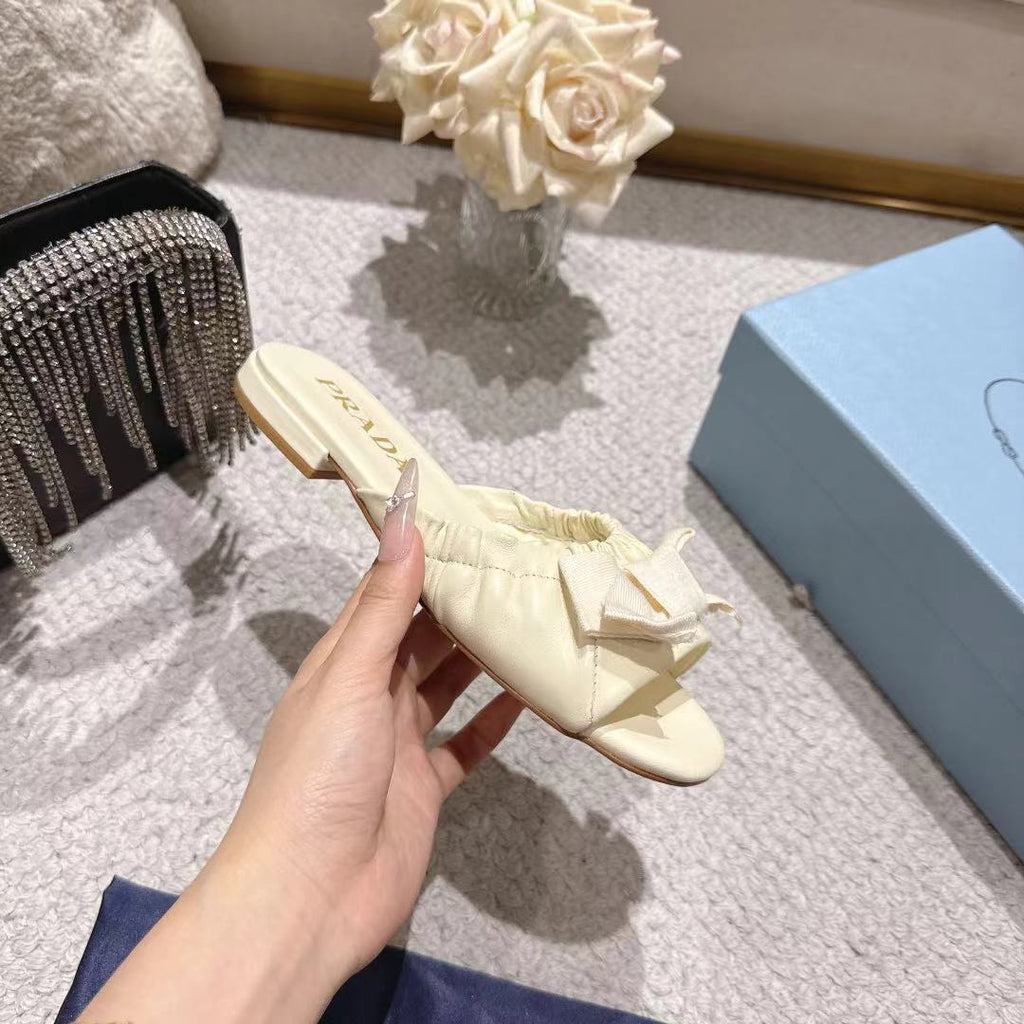 PRADA 26S RUCHED BOW SLIDE SANDALS IN IVORY WHITE CALFSKIN