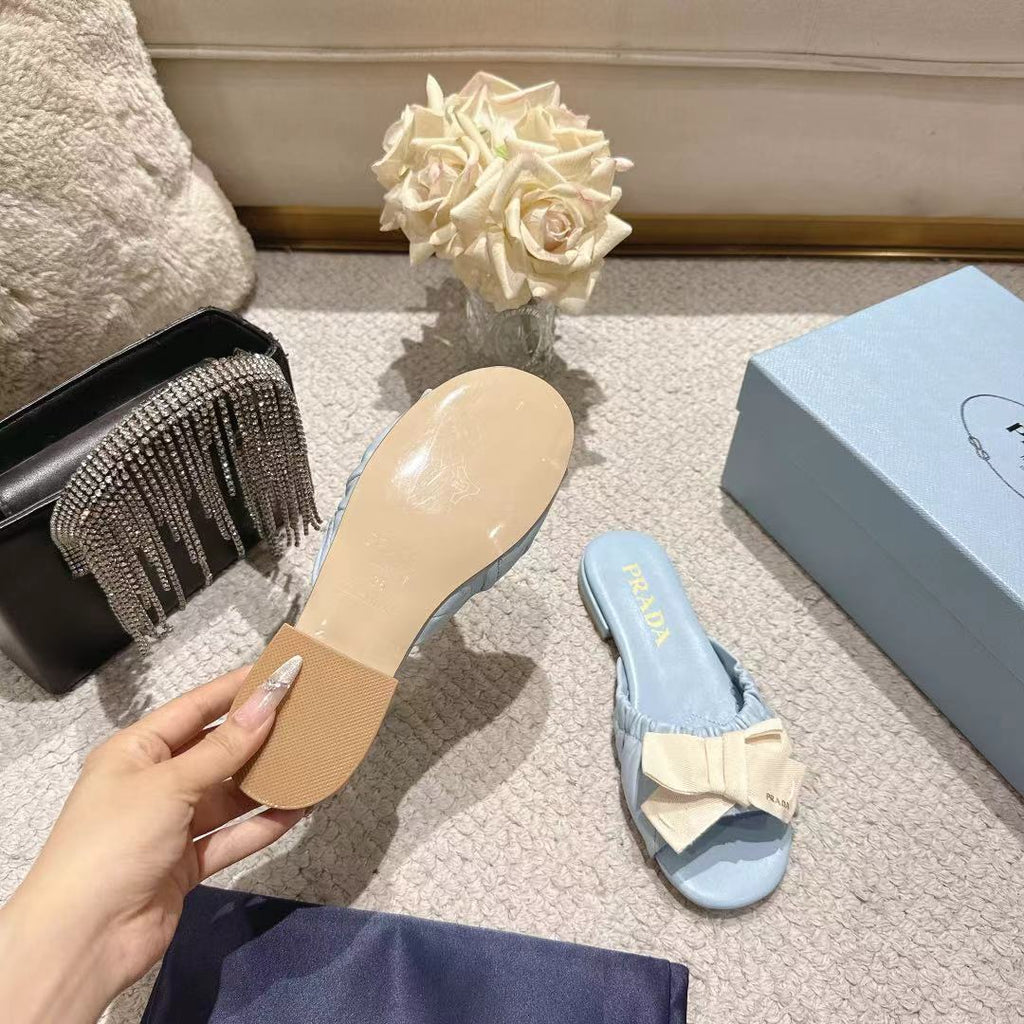 PRADA 26S RUCHED BOW SLIDE SANDALS IN LIGHT BLUE CALFSKIN